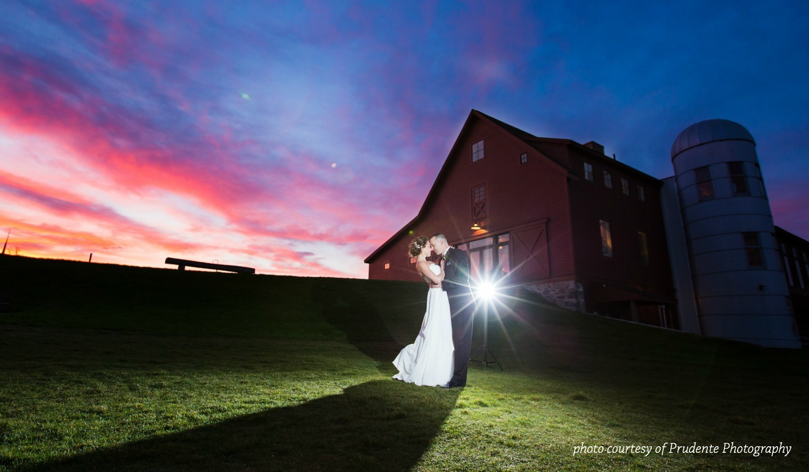 Married couple with sunset and barn in background